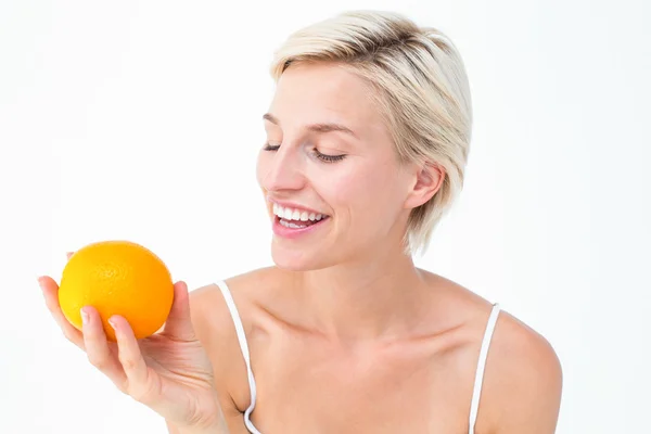 Mulher feliz segurando uma laranja — Fotografia de Stock