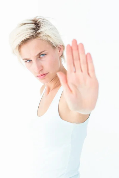 Enojada guapa rubia mostrando su mano — Foto de Stock