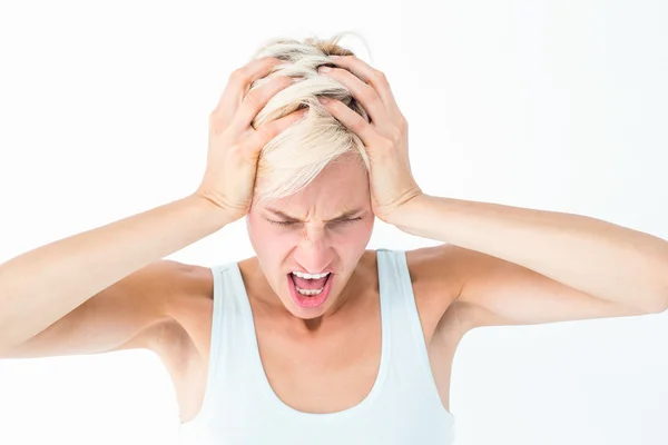 Angry blonde woman screaming and holding her head — Stock Photo, Image