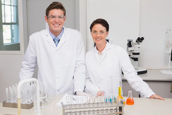 Scientists smiling and looking at camera — Stock Photo, Image