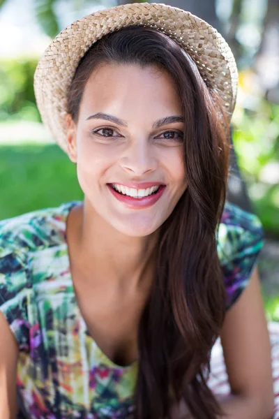 Smiling beautiful brunette lying on the blanket — Stock Photo, Image