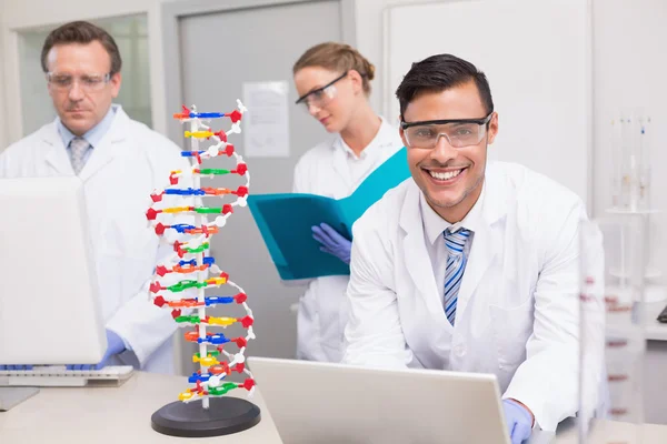 Scientist working with laptop and computer — Stock Photo, Image