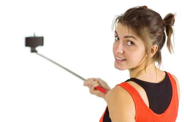 Casual brunette using selfie stick — Stock Photo, Image