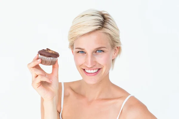 Pretty blonde holding chocolate muffin — Stock Photo, Image