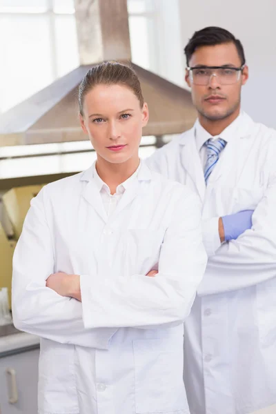 Scientists looking at camera with arms crossed — Stock Photo, Image