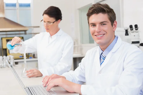 Scientist working attentively with laptop — Stock Photo, Image