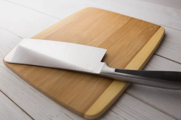 Chopping board with large knife — Stock Photo, Image