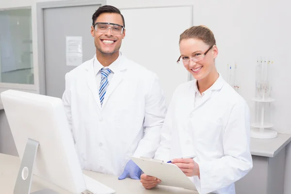 Happy scientists smiling at camera — Stock Photo, Image