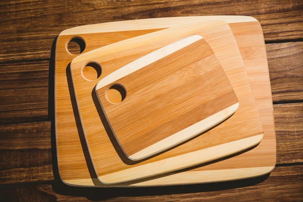Chopping boards on wooden table — Stock Photo, Image