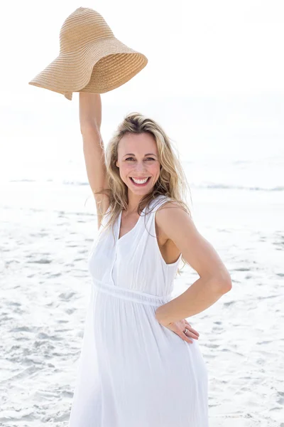 Blonde in white dress holding straw hat — Stock Photo, Image