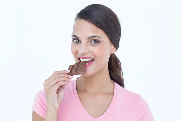 Beautiful woman eating chocolate — Stock Photo, Image