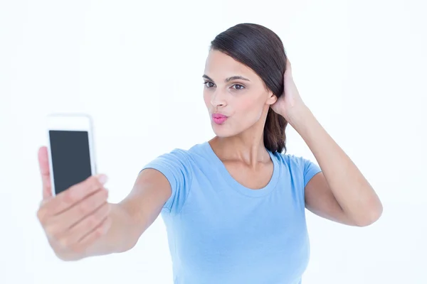 Beautiful brunette taking a selfie — Stock Photo, Image