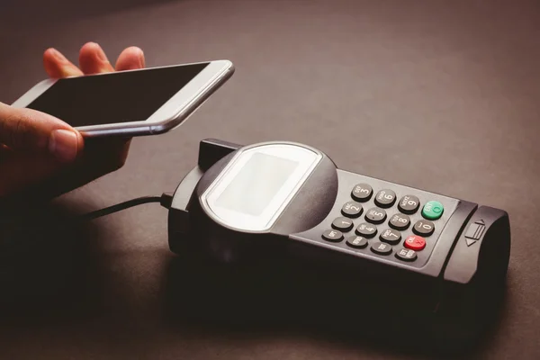 Man using smartphone to express pay — Stock Photo, Image