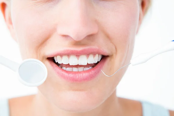 Pretty woman holding dental tools — Stock Photo, Image