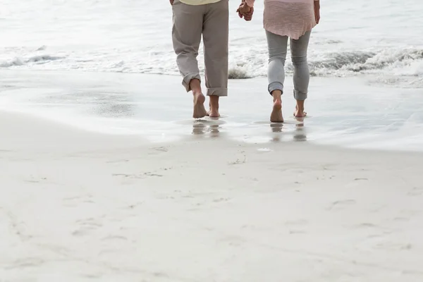 Gelukkige paar wandelen door de zee — Stockfoto