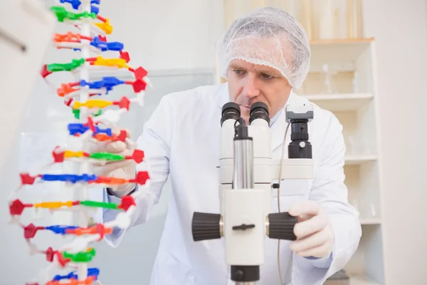 Scientist examining dna helix — Stock Photo, Image