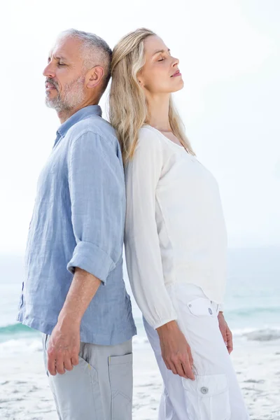 Happy couple standing back to back — Stock Photo, Image