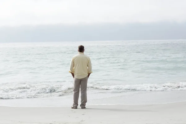 Thoughtful man standing by the sea — Stock Photo, Image