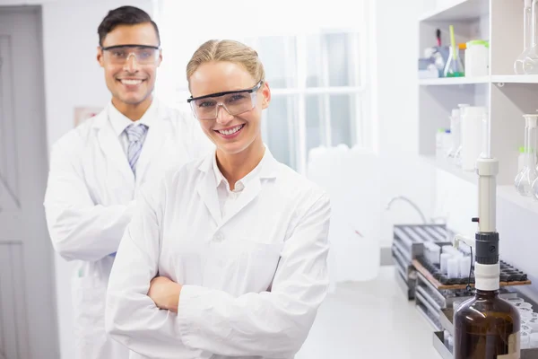 Smiling scientists looking at camera arms crossed — Stock Photo, Image