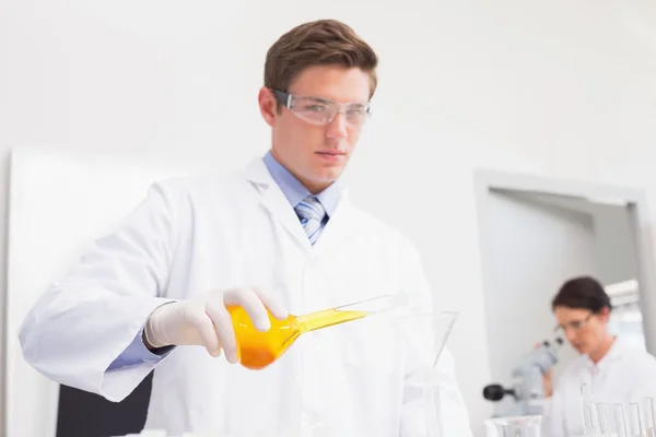 Scientists working with test tube and microscope — Stock Photo, Image