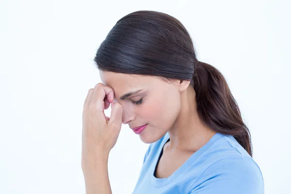 Brunette with a headache and hand on forehead — Stock Photo, Image