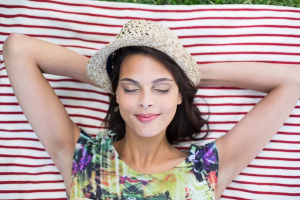 Smiling beautiful brunette lying on the blanket — Stock Photo, Image