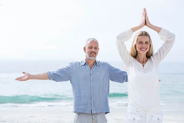 Happy couple doing yoga together — Stock Photo, Image