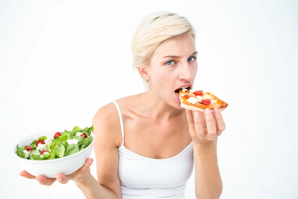 Mujer bonita decidiendo comer pizza en lugar de la ensalada — Foto de Stock