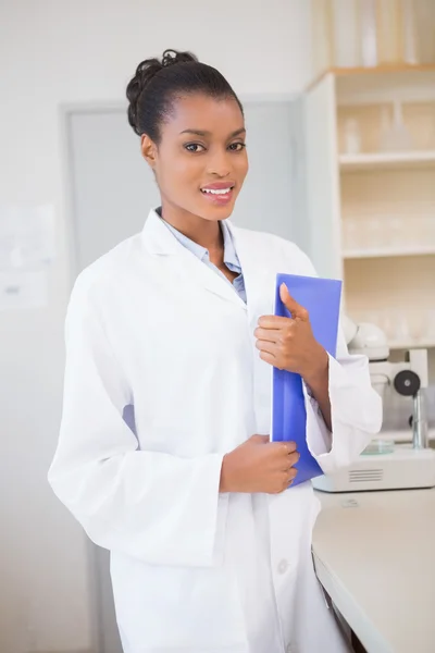 Smiling scientist holding file — Stock Photo, Image