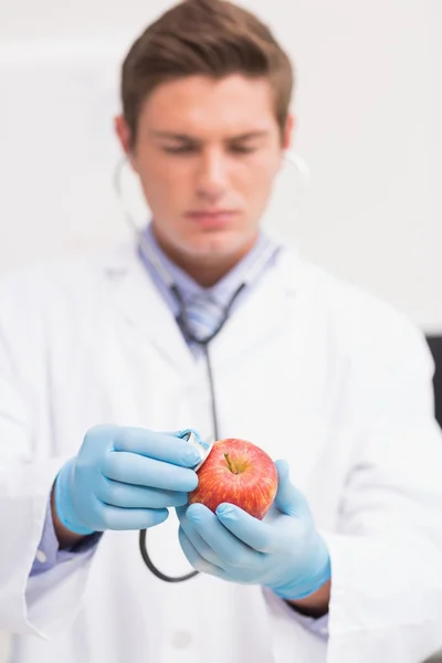 Naukowiec słuchania jabłko z stetoskop — Zdjęcie stockowe