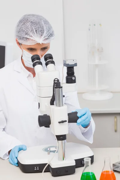 Scientist working attentively with microscope — Stock Photo, Image