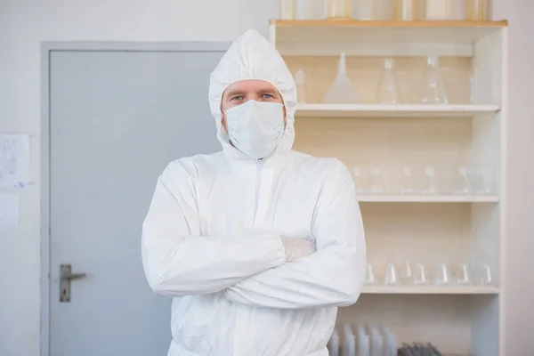 Scientist in protective suit with arms crossed — Stock Photo, Image