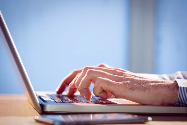 Businessman using laptop at desk — Stock Photo, Image