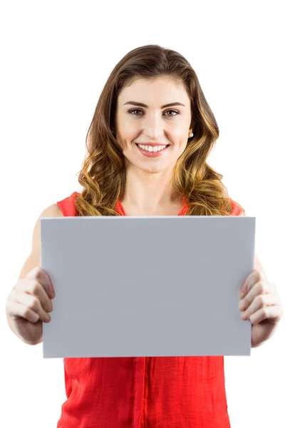 Pretty brunette woman showing a card — Stock Photo, Image