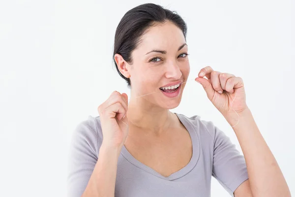 Mujer usando hilo dental —  Fotos de Stock