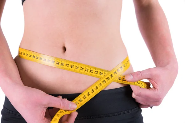 Slim woman measuring waist with tape measure — Stock Photo, Image