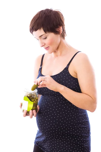 Pregnant woman eating jar of pickles — Stock Photo, Image