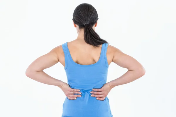 Pretty brunette suffering from back pain — Stock Photo, Image