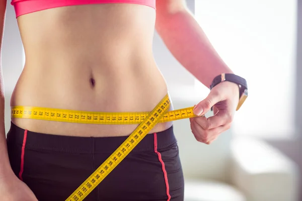 Slim woman measuring waist — Stock Photo, Image