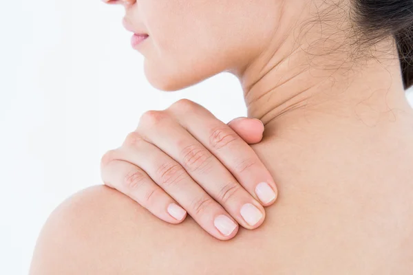 Brunette touching her painful shoulder — Stock Photo, Image
