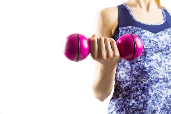 Fit woman lifting pink dumbbell — Stock Photo, Image