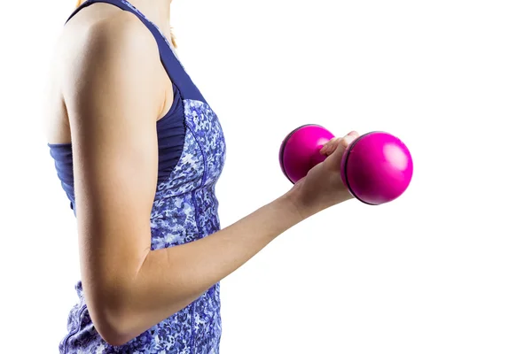 Fit woman lifting pink dumbbell — Stock Photo, Image
