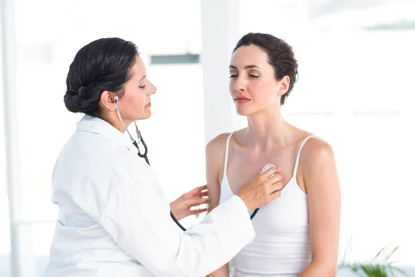 Läkaren lyssnar på patienter bröstet med stetoskop — Stockfoto