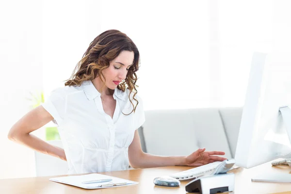 Businesswoman suffering from backache — Stock Photo, Image