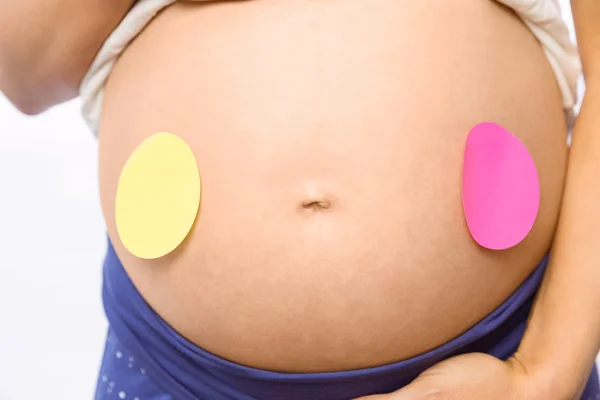 Pregnant woman with sticker on bump — Stock Photo, Image