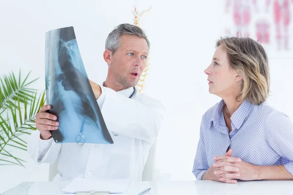 Doutor mostrando raio-x para seu paciente — Fotografia de Stock