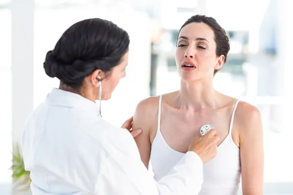 Läkaren lyssnar på patienter bröstet med stetoskop — Stockfoto