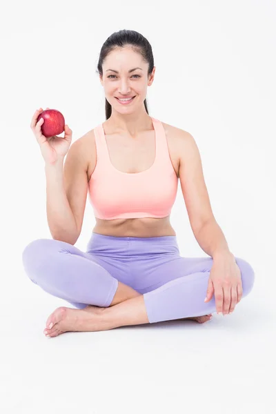 Pretty brunette holding red apple — Stock Photo, Image