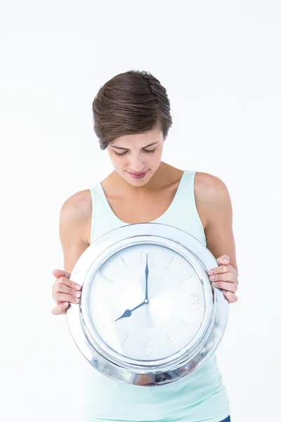 Natural brunette woman holding clock — Stock Photo, Image
