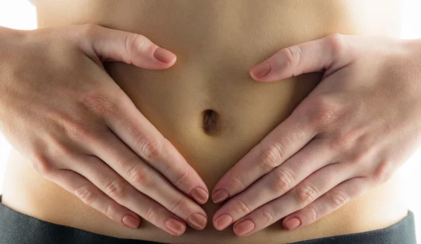 Slim woman touching her belly — Stock Photo, Image
